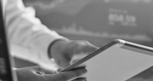 expert looking at financial data on a tablet expert looking at financial data on a tablet
